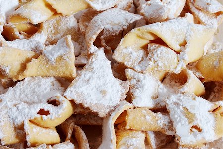 Group of traditional Italian carnival biscuits sprinkled with icing sugar Stock Photo - Budget Royalty-Free & Subscription, Code: 400-05307484