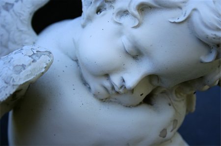 Close up of a cherub with closed eyes, hugging its knees. Stock Photo - Budget Royalty-Free & Subscription, Code: 400-05307512
