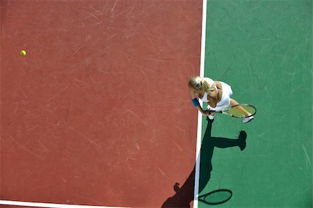 simsearch:400-06061549,k - young fit woman play tennis outdoor on orange tennis field at early morning Photographie de stock - Aubaine LD & Abonnement, Code: 400-05308154