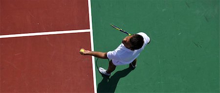 simsearch:400-06061549,k - young man play tennis outdoor on orange tennis field at early morning Photographie de stock - Aubaine LD & Abonnement, Code: 400-05308417