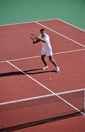 simsearch:400-06061549,k - young fit woman play tennis outdoor on orange tennis field at early morning Photographie de stock - Aubaine LD & Abonnement, Code: 400-05308957