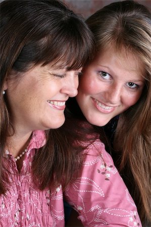 simsearch:400-04747810,k - Beautiful mother and daughter against a brick-wall background Stock Photo - Budget Royalty-Free & Subscription, Code: 400-05308964