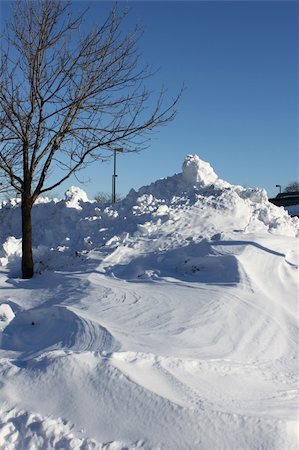 High pile of snow accumulated at the parking lot after the storm Stock Photo - Budget Royalty-Free & Subscription, Code: 400-05309223