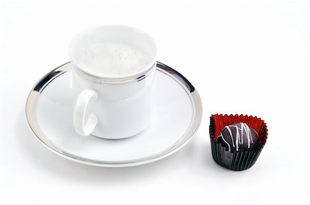 Afternoon indulgence: capucino coffee or latte served in fancy gold trim cup and saucer with chocolate. Stock Photo - Budget Royalty-Free & Subscription, Code: 400-05309456