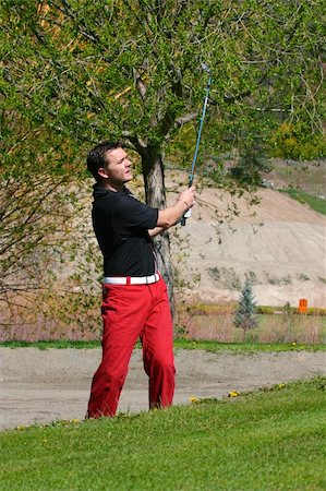 simsearch:400-04942642,k - Young male golfer playing a shot from the bunker Photographie de stock - Aubaine LD & Abonnement, Code: 400-05309477