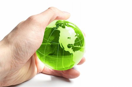 eco travel - ecology concept with hand and glass globe isolated on white background Foto de stock - Super Valor sin royalties y Suscripción, Código: 400-05309887
