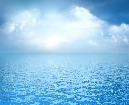 Beautiful blue ocean with white clouds on horizon Fotografie stock - Microstock e Abbonamento, Codice: 400-05300680