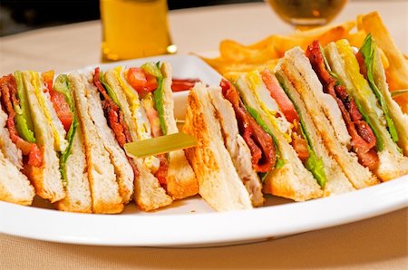 simsearch:400-08188042,k - fresh triple decker club sandwich with french fries on side Photographie de stock - Aubaine LD & Abonnement, Code: 400-05301128