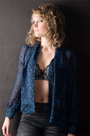 sexy blond curly haired woman in blue shirt and bra against a black wall Foto de stock - Super Valor sin royalties y Suscripción, Código: 400-05301514
