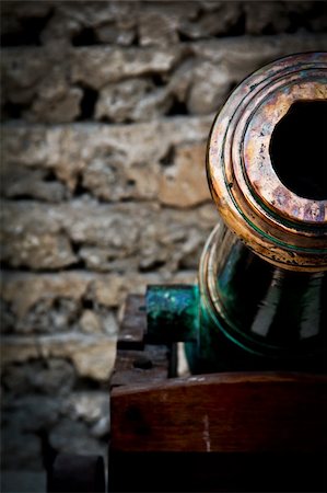 an old rusted canon against a brick wall Stock Photo - Budget Royalty-Free & Subscription, Code: 400-05301691