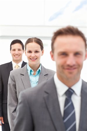 simsearch:6109-06002735,k - Young businesswoman posing with two businessmen in a row at work Stock Photo - Budget Royalty-Free & Subscription, Code: 400-05301814