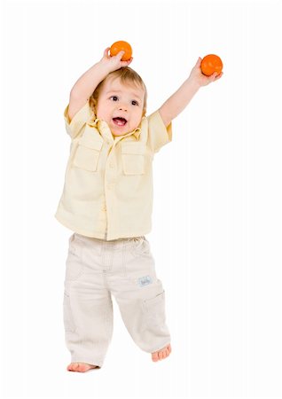 Little boy playing with tangerines over white Fotografie stock - Microstock e Abbonamento, Codice: 400-05302195