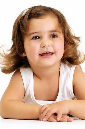 Little beautiful girl looking and smiling whilst leaning on her arms Stockbilder - Microstock & Abonnement, Bildnummer: 400-05302800