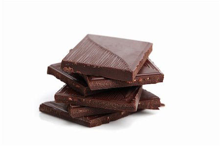 stacked chocolate bars - Stack of dark chocolate pieces on white background. Shallow dof Stock Photo - Budget Royalty-Free & Subscription, Code: 400-05302823