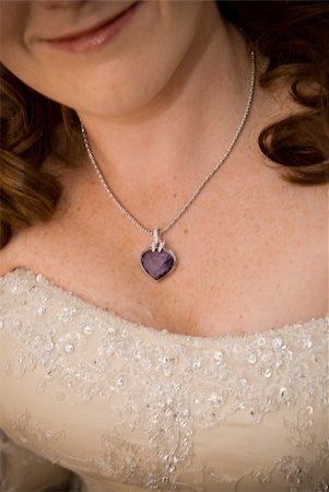 sexy red head bride showing her purple stoned necklace and cleavage Stockbilder - Microstock & Abonnement, Bildnummer: 400-05302906