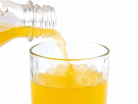 Fresh orange juice pouring in glass on a white close-up Fotografie stock - Microstock e Abbonamento, Codice: 400-05302929