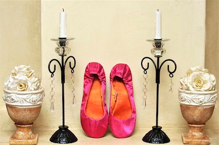 pink wedding shoes next to candle holders on mantle piece Stockbilder - Microstock & Abonnement, Bildnummer: 400-05303366