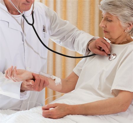 Senior doctor taking the heartbeat of his patient Stock Photo - Budget Royalty-Free & Subscription, Code: 400-05314265