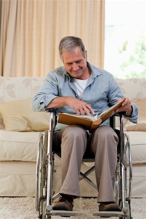 Senior man looking at his photo album at home Stock Photo - Budget Royalty-Free & Subscription, Code: 400-05314314