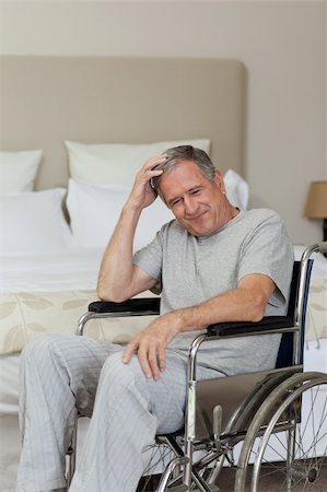 Smiling senior man in his wheelchair  at home Stock Photo - Budget Royalty-Free & Subscription, Code: 400-05314470