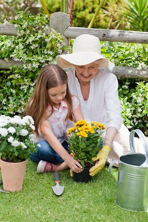 pictures of can and flowers - Grandmother with her granddaughter working in the garden Stock Photo - Budget Royalty-Free & Subscription, Code: 400-05314668