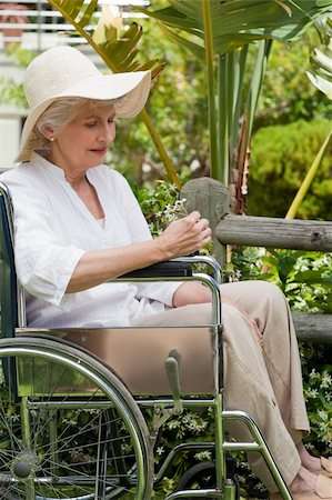 Mature woman in her wheelchair in the garden Stock Photo - Budget Royalty-Free & Subscription, Code: 400-05314661