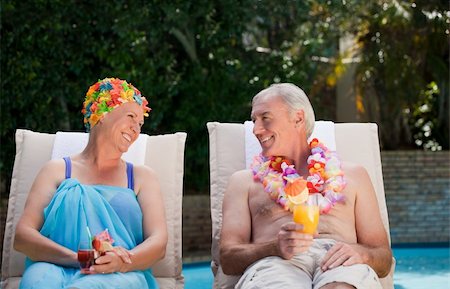 Mature couple drinking a cocktail  beside the swimming pool at home Stock Photo - Budget Royalty-Free & Subscription, Code: 400-05314738