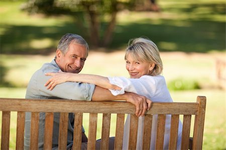 Happy retired couple sitting on the bench Stock Photo - Budget Royalty-Free & Subscription, Code: 400-05315003