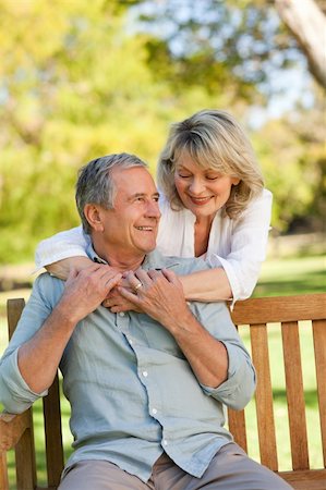 Senior woman hugging her husband who is on the bench Stock Photo - Budget Royalty-Free & Subscription, Code: 400-05315015