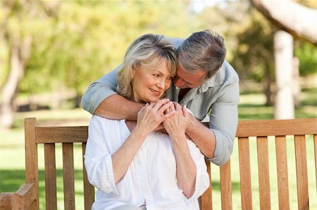 Elderly man hugging his wife who is on the bench Stock Photo - Budget Royalty-Free & Subscription, Code: 400-05315013