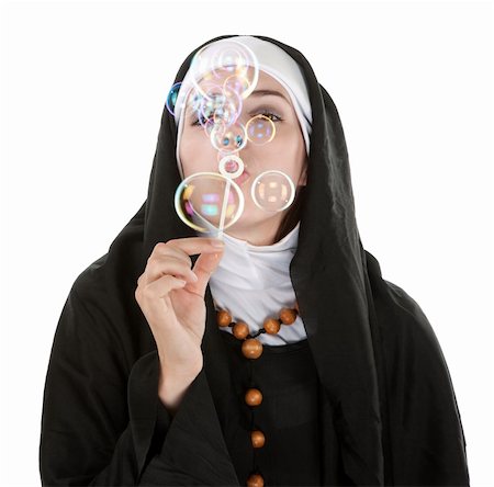 simsearch:400-05315102,k - Young nun on white background blowing bubbles Photographie de stock - Aubaine LD & Abonnement, Code: 400-05315103
