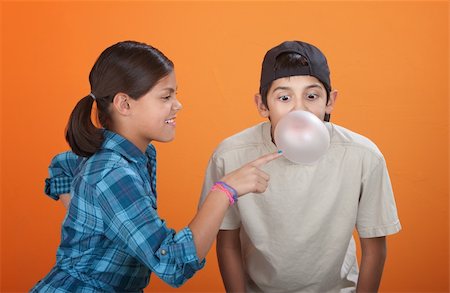 Girl touching a bubble blown by her brother with chewing gum Stock Photo - Budget Royalty-Free & Subscription, Code: 400-05315155