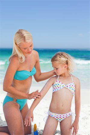 Mother applying sun cream on her daughter Stock Photo - Budget Royalty-Free & Subscription, Code: 400-05316515