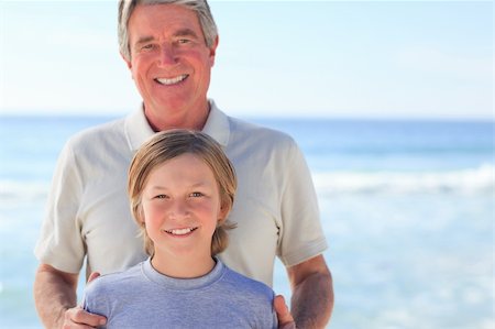 Grandfather with his grandson on the beach Stock Photo - Budget Royalty-Free & Subscription, Code: 400-05316843