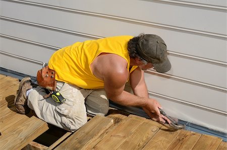 A carpenter hammering on a deck patio Stock Photo - Budget Royalty-Free & Subscription, Code: 400-05317349