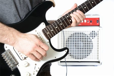 rock speakers - Guitarist playing a solo with the amp in the background. Foto de stock - Super Valor sin royalties y Suscripción, Código: 400-05317358