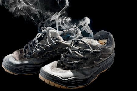 pair of smelly old sneakers on a black background Foto de stock - Super Valor sin royalties y Suscripción, Código: 400-05318197