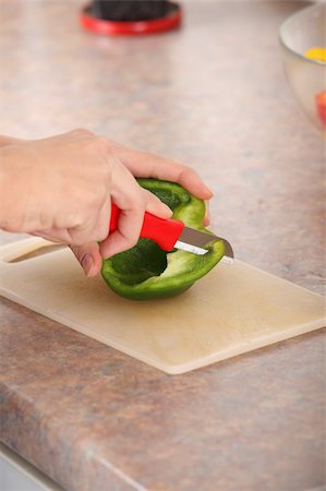 simsearch:400-04347888,k - Female chopping food ingredients (paprika) on the kitchen. Stockbilder - Microstock & Abonnement, Bildnummer: 400-05318474