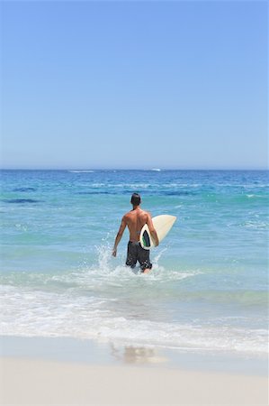simsearch:400-05319489,k - Man running on the beach with his surfboard Stock Photo - Budget Royalty-Free & Subscription, Code: 400-05318853