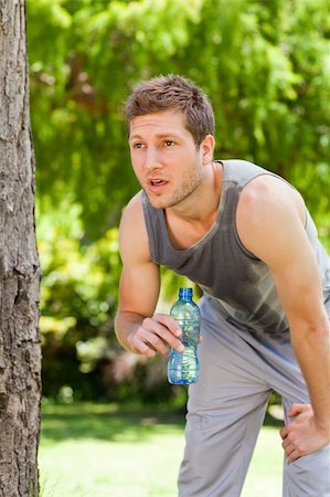 Sporty man drinking water in the park Stock Photo - Budget Royalty-Free & Subscription, Code: 400-05319531