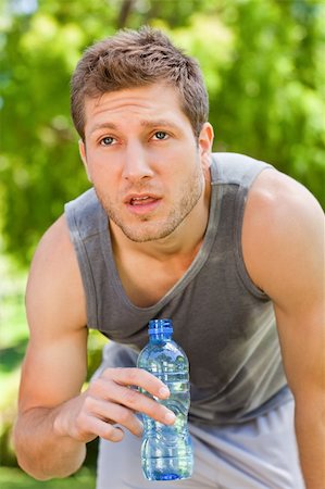 Sporty man drinking water in the park Stock Photo - Budget Royalty-Free & Subscription, Code: 400-05319532
