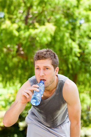 Sporty man drinking water in the park Stock Photo - Budget Royalty-Free & Subscription, Code: 400-05319533