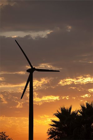 simsearch:400-04339274,k - Silhouetted Wind Turbine Over Dramatic Sunset Sky and Clouds. Fotografie stock - Microstock e Abbonamento, Codice: 400-05319711