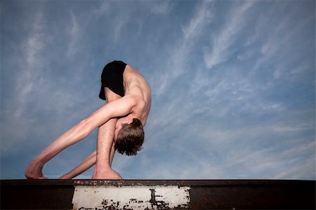 simsearch:400-04328141,k - Extremely flexible yoga practitioner outside on rail track Stock Photo - Budget Royalty-Free & Subscription, Code: 400-05319880