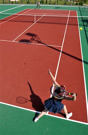 simsearch:400-06061549,k - young fit woman play tennis outdoor on orange tennis field at early morning Photographie de stock - Aubaine LD & Abonnement, Code: 400-05310027