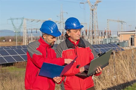 solar panels and discussion - Engineers at Work In a Solar Power Station Stock Photo - Budget Royalty-Free & Subscription, Code: 400-05310275