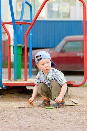 Boy on playground looking up summer sunny day Stock Photo - Budget Royalty-Free & Subscription, Code: 400-05310463