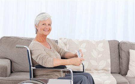 simsearch:400-04327275,k - Woman looking at the camera in her wheelchair Stockbilder - Microstock & Abonnement, Bildnummer: 400-05310732