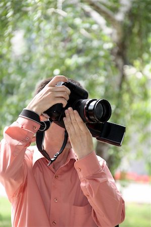 paparazzi taking pictures of man background - Man with pro digital camera Photographie de stock - Aubaine LD & Abonnement, Code: 400-05311122