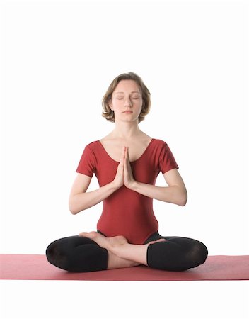 Woman sitting in lotus pose on a mat over white background Stock Photo - Budget Royalty-Free & Subscription, Code: 400-05311836